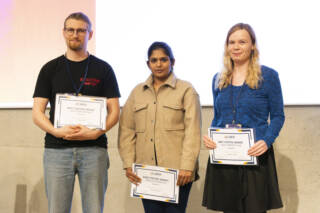 3 people with poster award certificates in hands