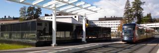 A tram approaching a tram stop.