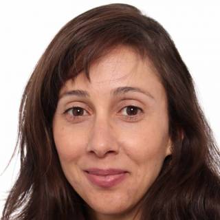 A smiling woman with brown hair.