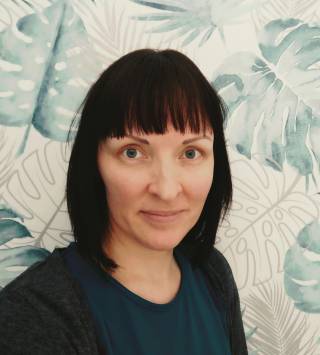 A smiling woman with dark hair.