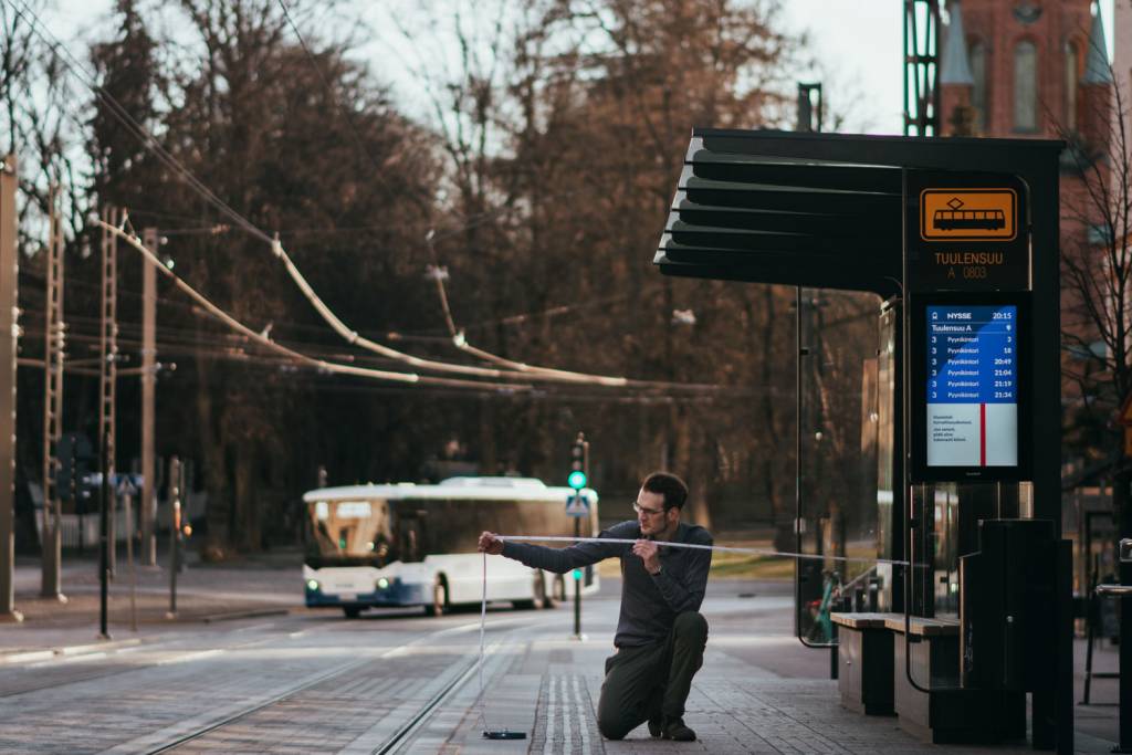 Christoph Aberle takes measurements at a Tampere tram stop