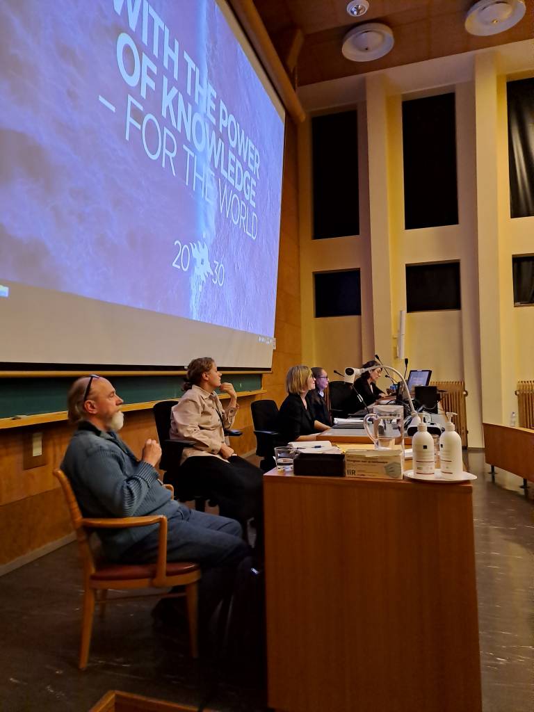 Picture of panelists in a conference