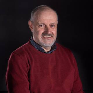 A portrait photo against black background.