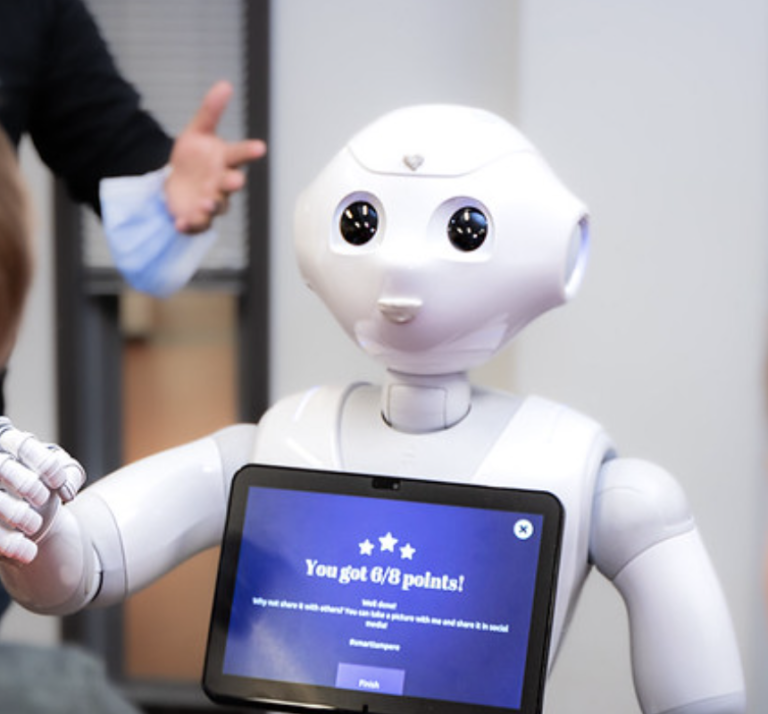 A photo of the Pepper robot in Robostudio, where visitors can interact with Boston Dynamics' Spot and a variety of other advanced robots.