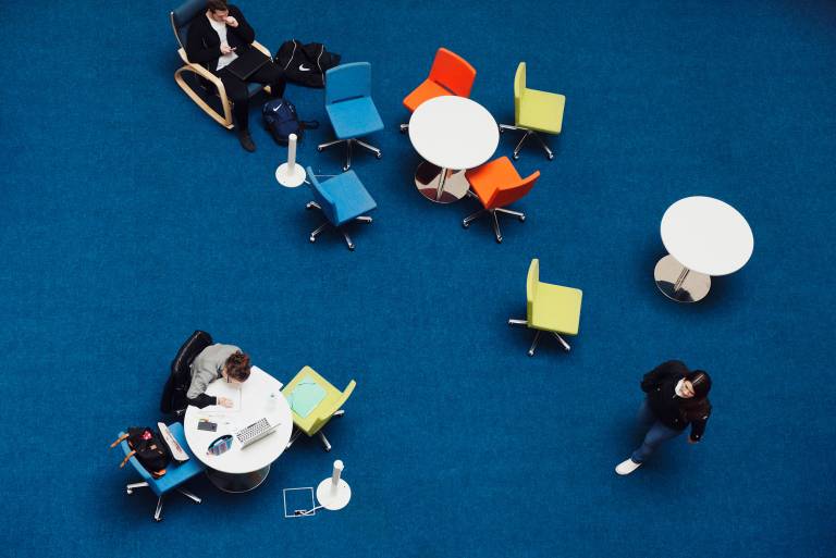 Tables and chairs on a dark blue floor.