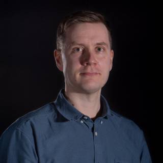 A portrait photo against black background.
