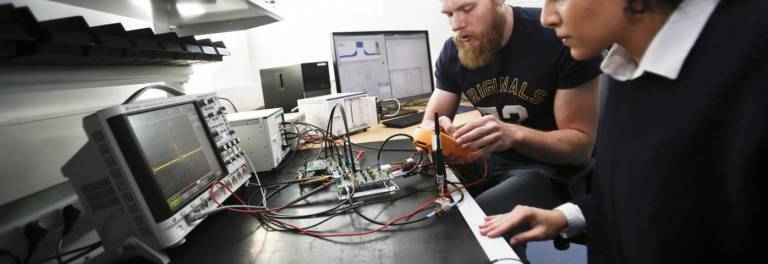 Two people at the RF Lab