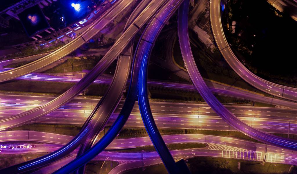 Aerial photo of highway crossroads at night.