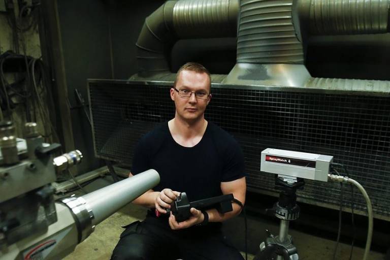 Man with a thermal spray gun