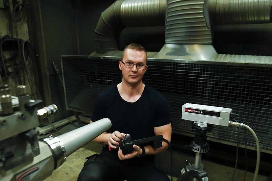 Man with a thermal spray gun