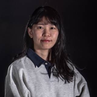A portrait photo against black background.