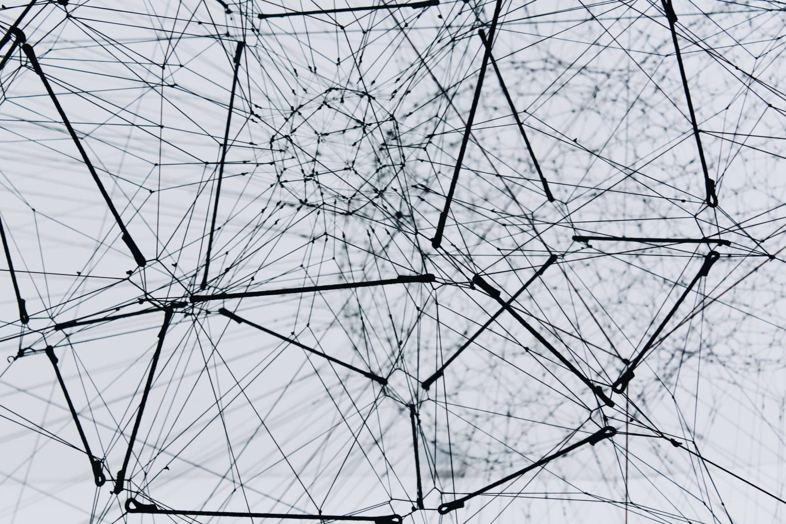 A vast web of wires, intricately woven together forming a variety of planes and geometric shapes.