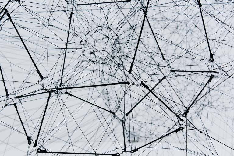 A vast web of wires, intricately woven together forming a variety of planes and geometric shapes.