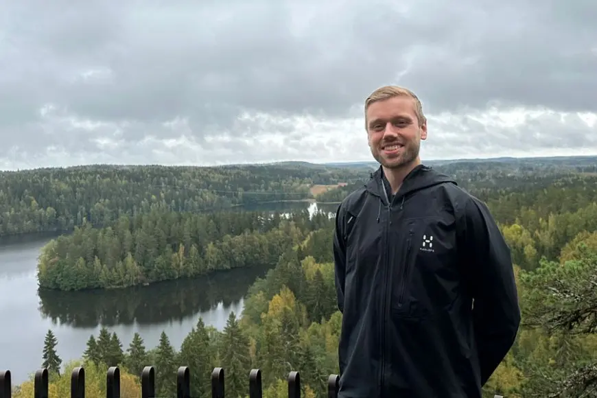 Profile picture of Hans Jakob Damsgaard. Forest and lake in the background. Photo by: Anna Gaydamaka