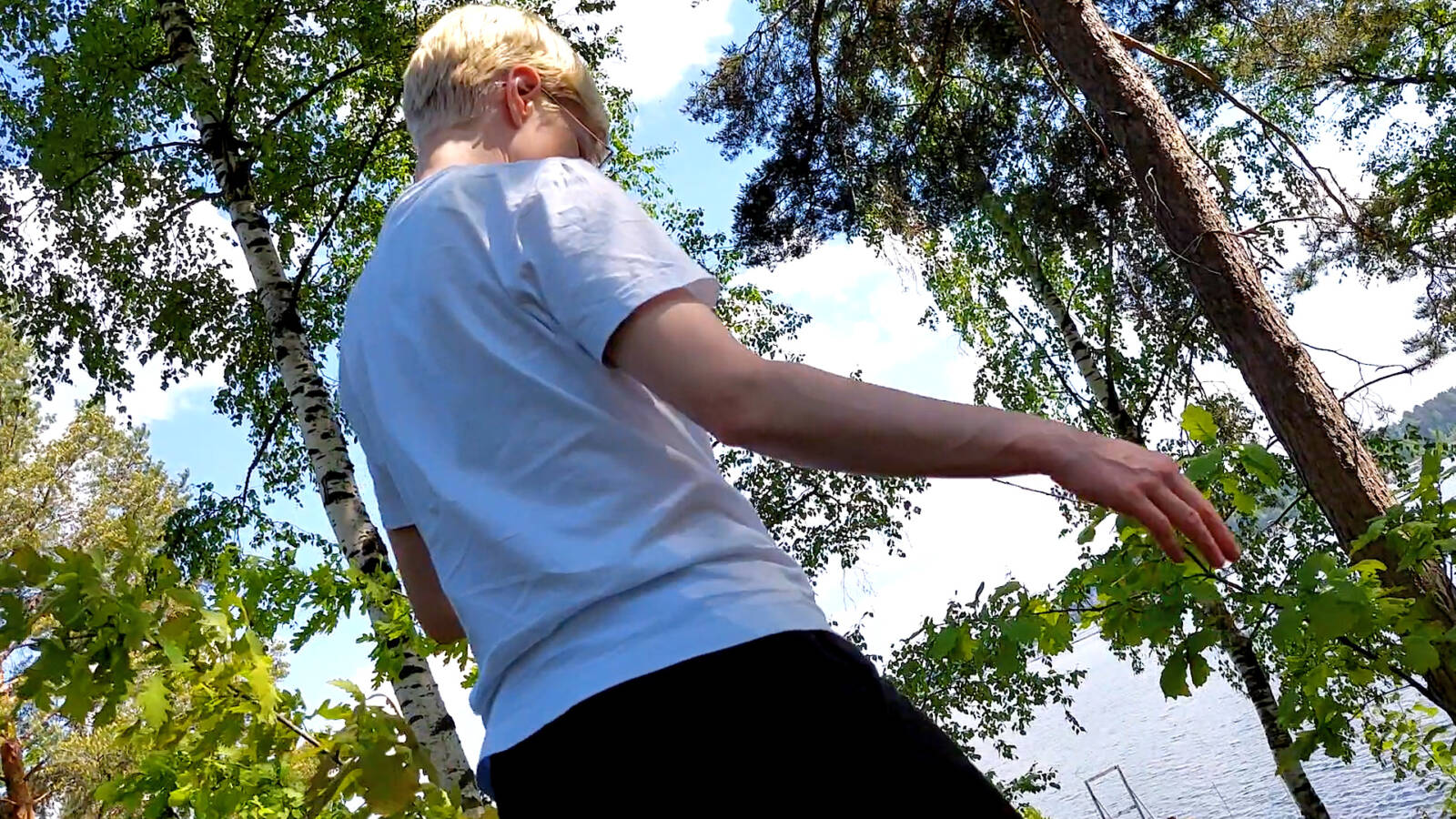 A person standing and moving in nature.