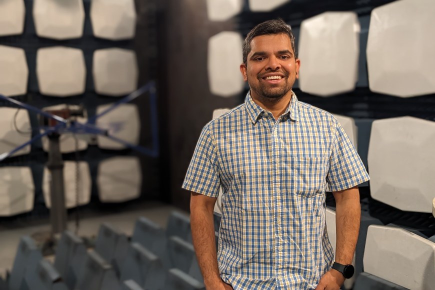 Profile photo of Nachiket Ayir standing inside EMC chamber
