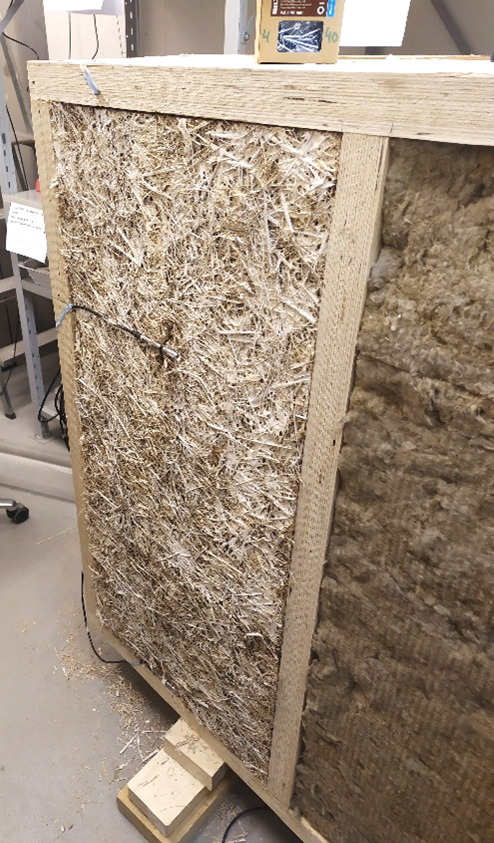 Wall structure insulated with mycelium and mineral wool.