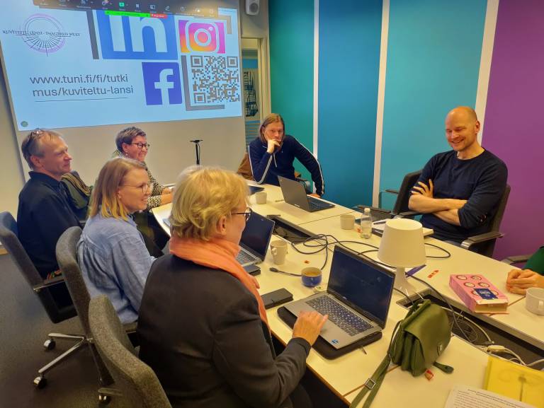 People sitting by a table at a meeting