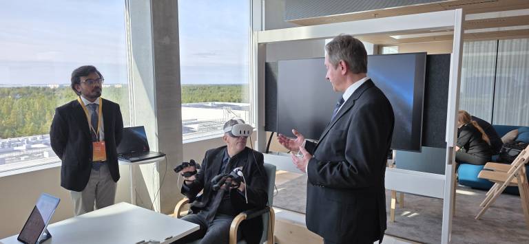 User with VR glasses and thermal haptic gloves