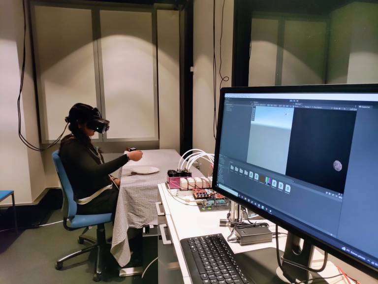 User with VR glasses and an olfactory necklace