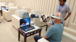 User with VR glasses and thermal haptic gloves