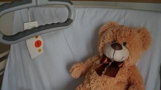 A teddybear on a hospital bed