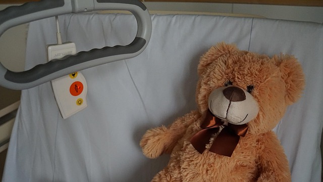 A teddybear on a hospital bed