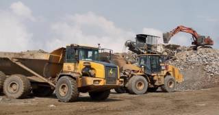 Representative image of mine with hauler, loader, and excavator