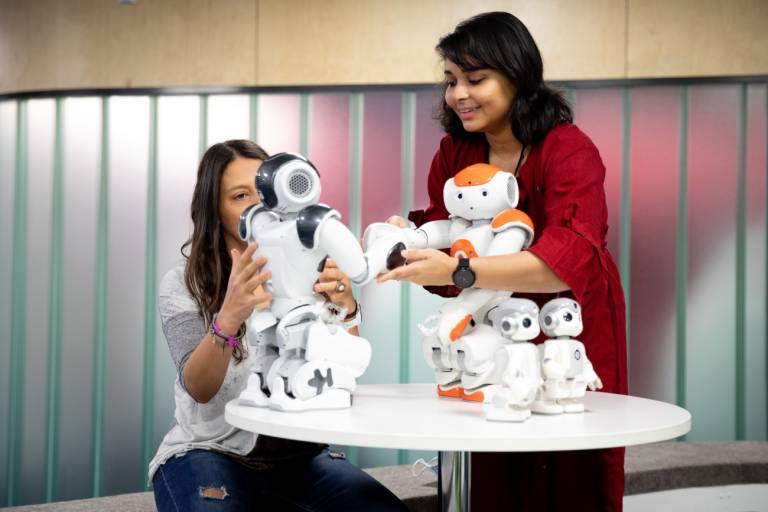 Salla Jarske and Aparajita Chowdhury testing out the robots