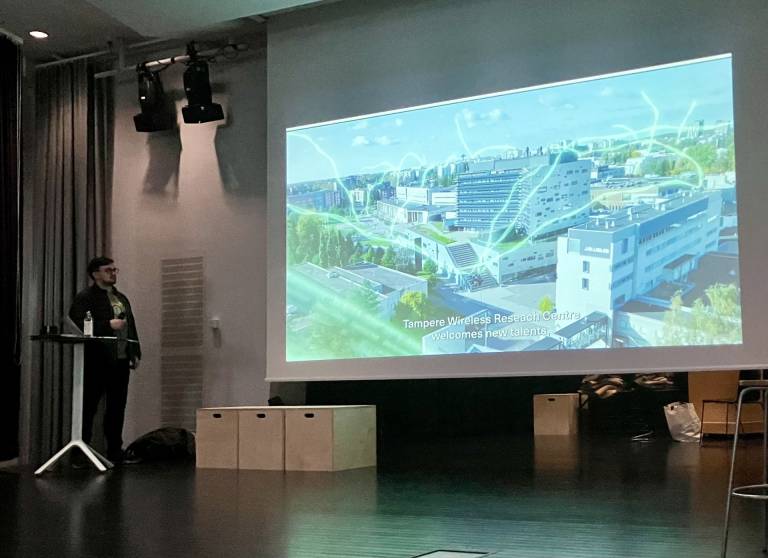 Picture of Aleksandr Ometov presenting TWRC.