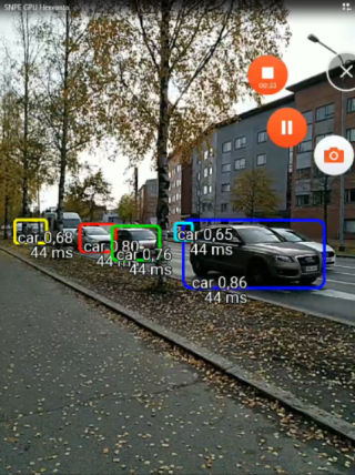 Vehicles detected by AI are highlighted in a screencapture.