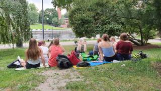 A group of young people from the CCC-CATAPULT project having a picnic in the Tampere city center park.