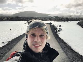 Alex Berdin's selfie with a road and snow on its sides background