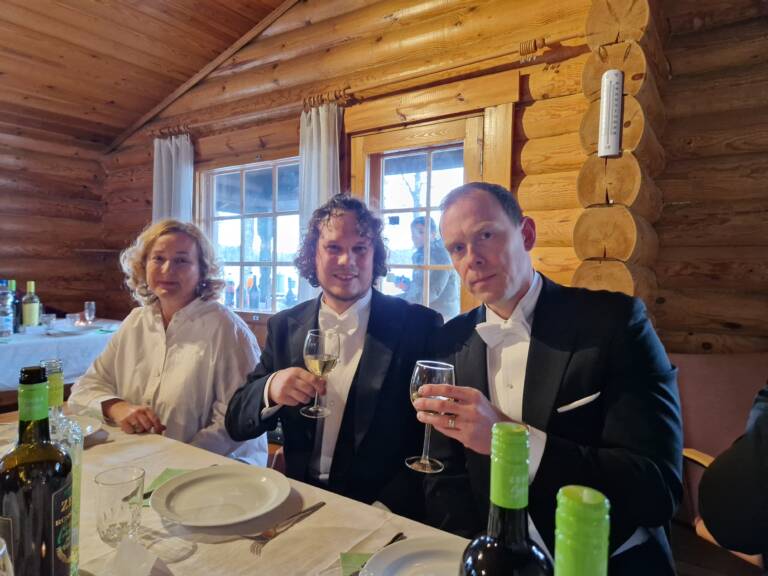 Prof. Svetlana Santer, Dr. Alex Berdin and Prof. Arri Priimägi sitting at the table, Alex and Arri with wine glasses up.