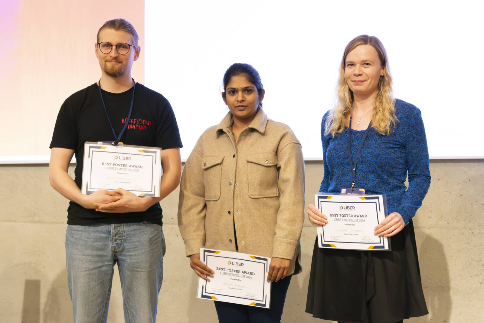 3 people with poster award certificates in hands